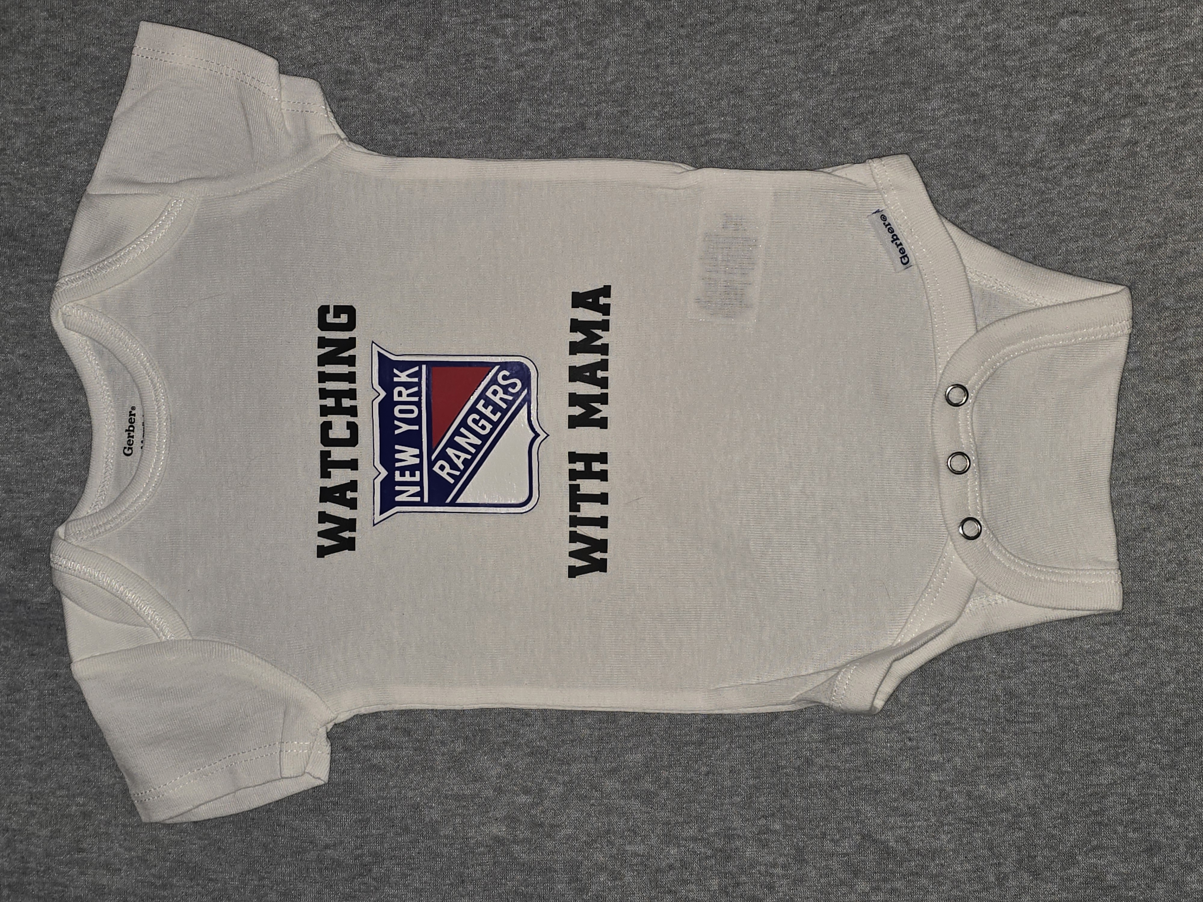 Sports team baby onesie watching with mama